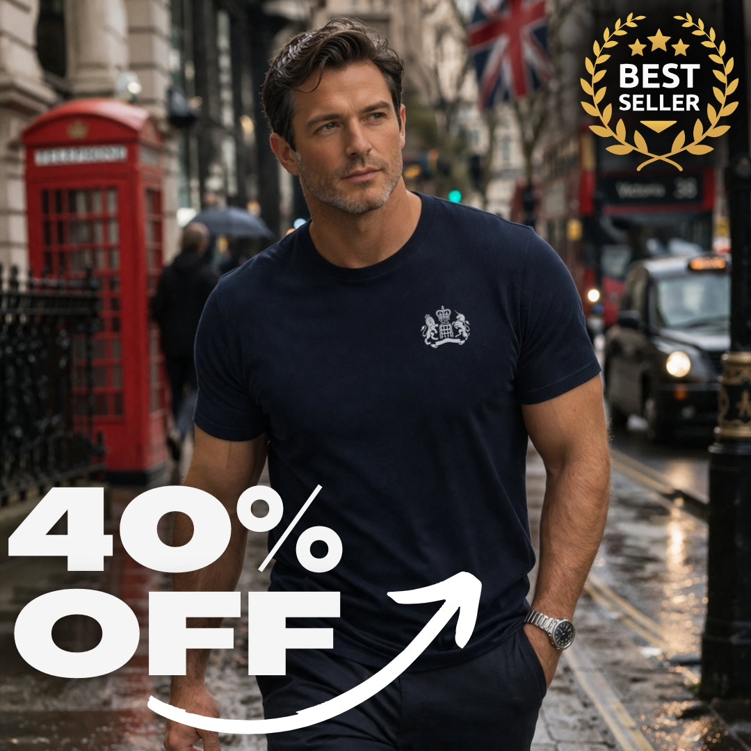Man wearing a navy blue James Bond t-shirt with a logo on a city street with a red phone booth and British flag in the background in London England.