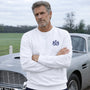 Man wearing James Bond Luxury Sweatshirt in White standing next to Aston Martin DB5