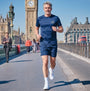 Man running on a bridge with Big Ben in the background