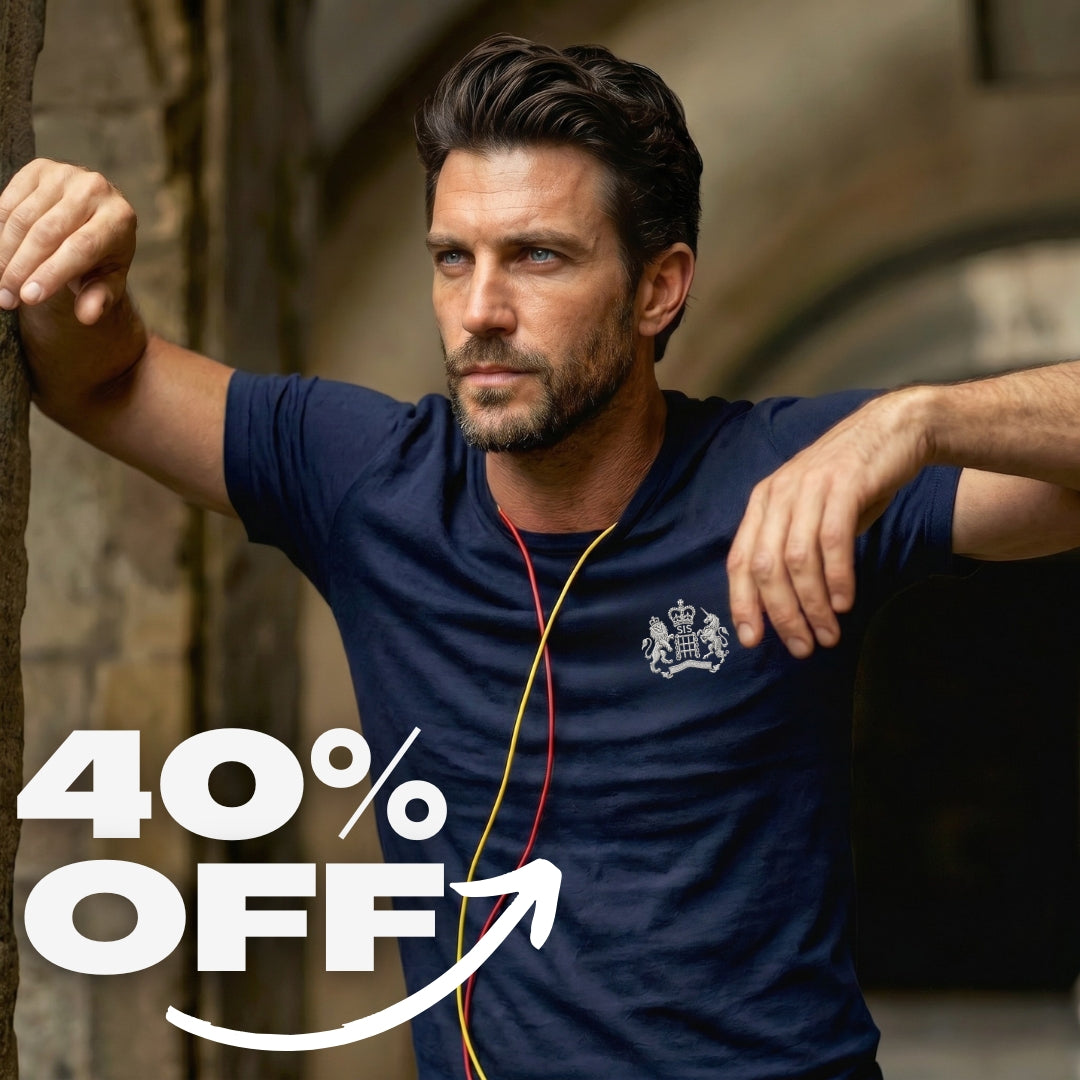 Man wearing a navy blue shirt with a logo, leaning against a stone wall, with '40% OFF' text overlay.